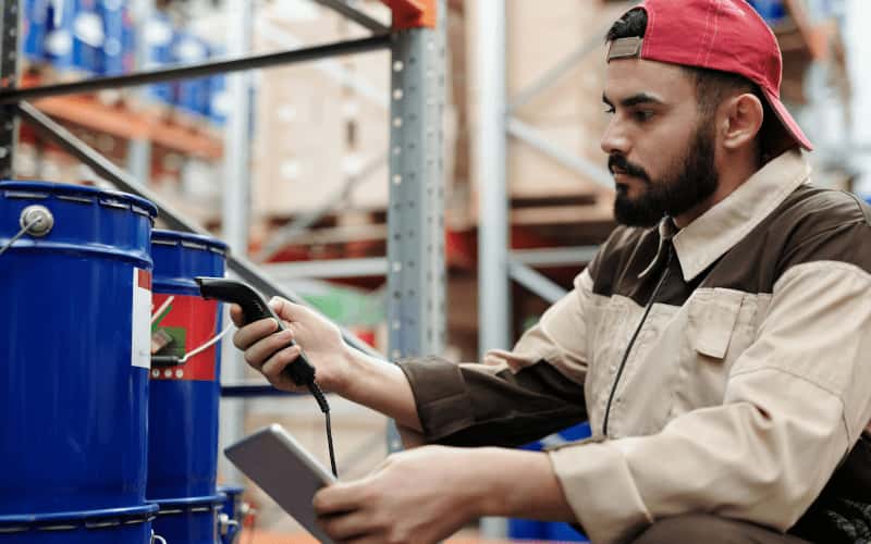 man labelling items in warehouse