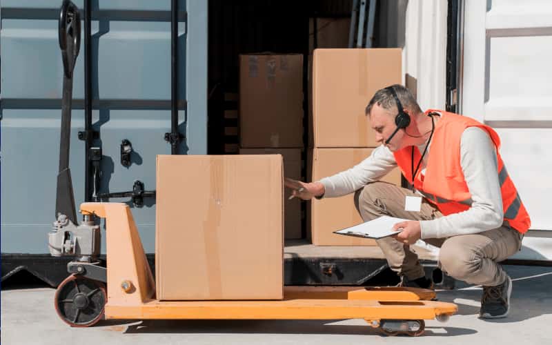 man loading and unloading container into warehouse storage