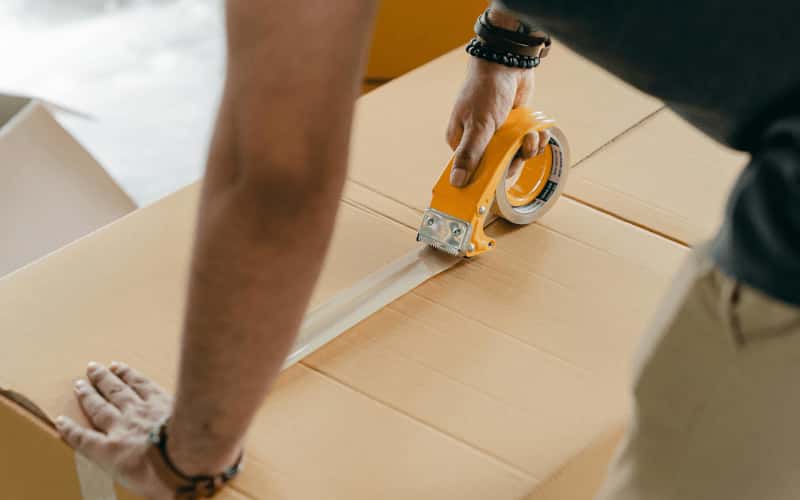 man packaging boxes in warehousing and storage