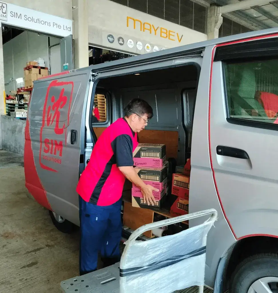 staff loading items into delivery van