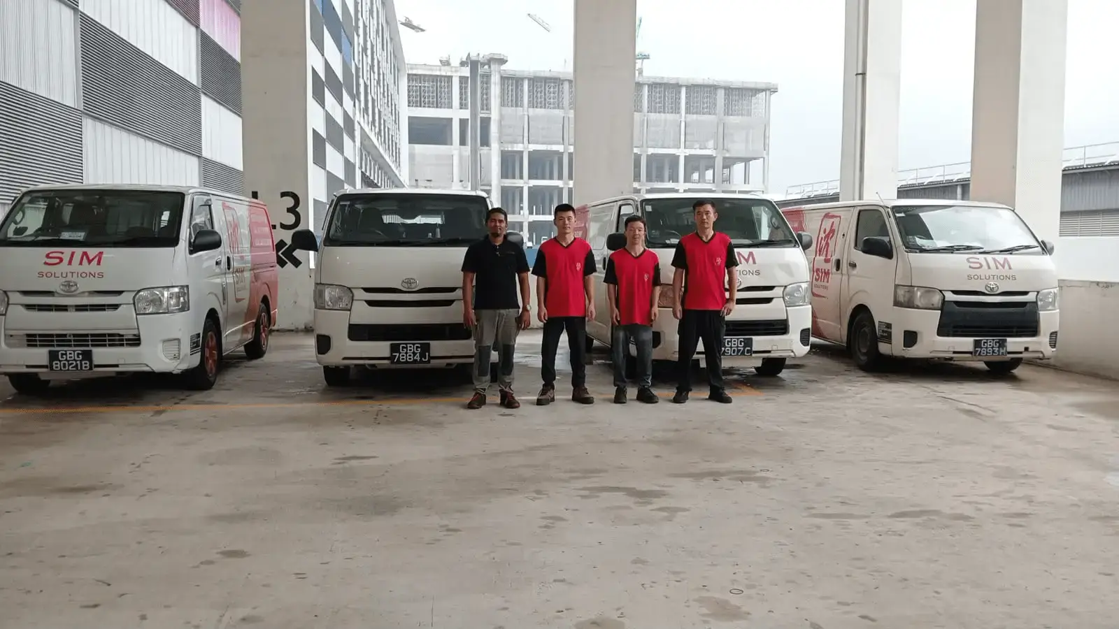 staff in front of delivery vans