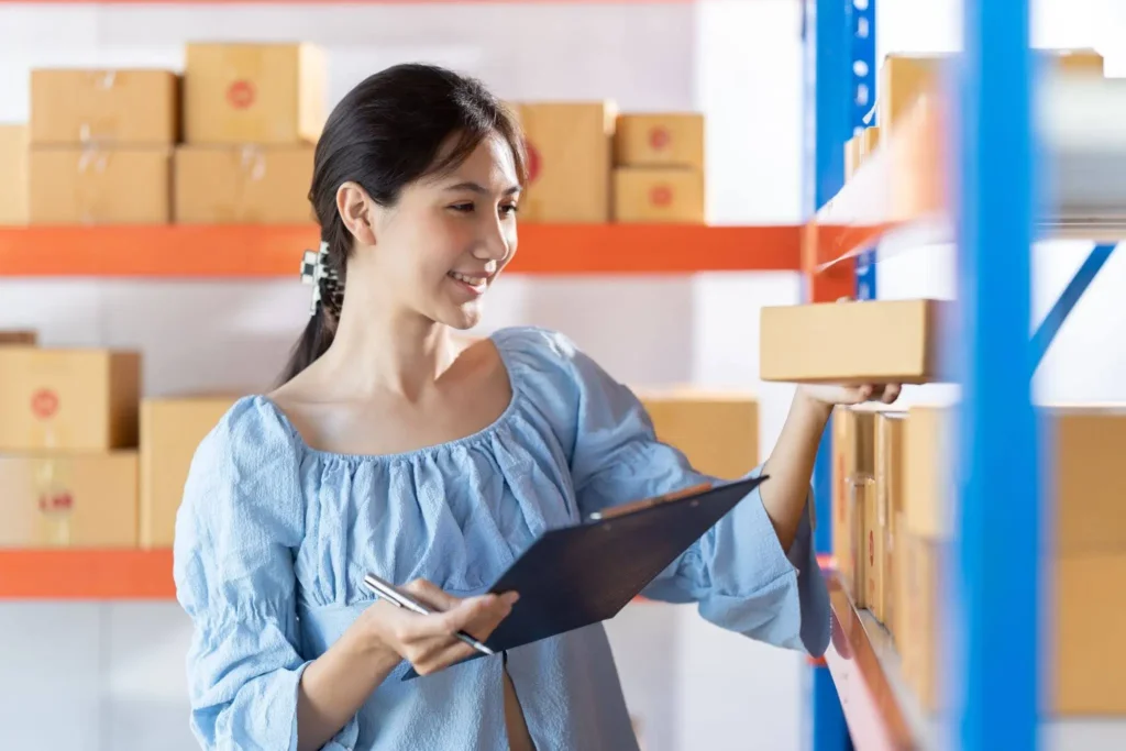 staff putting packages on shelf