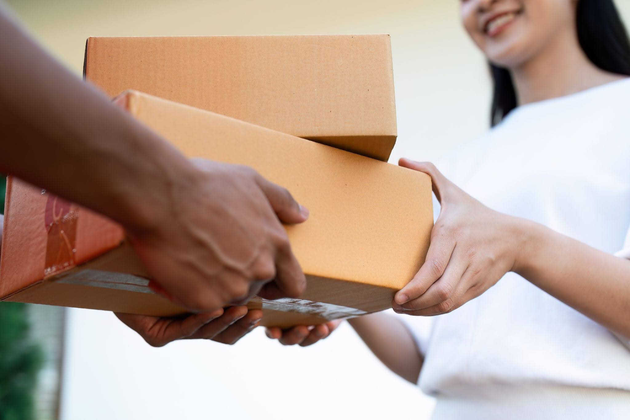 woman receiving packages from courier